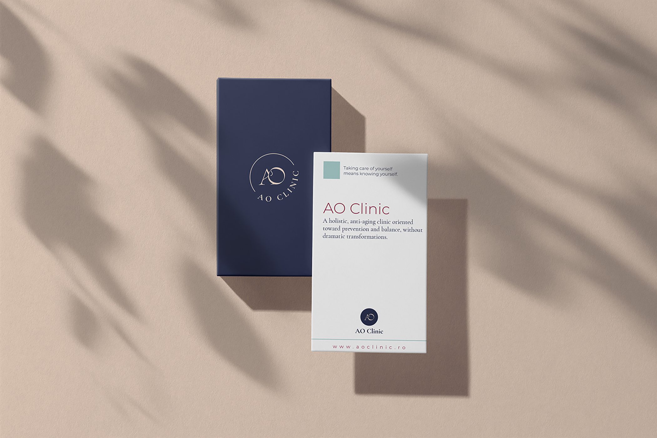 AO Clinic navy and white business cards on a blush background